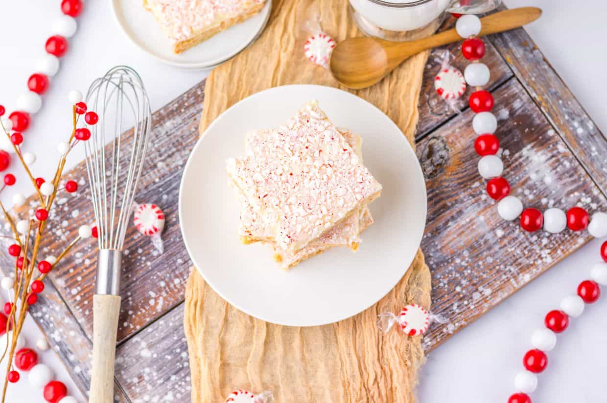 A festive display of peppermint sugar cookie bars surrounded by Christmas decorations.