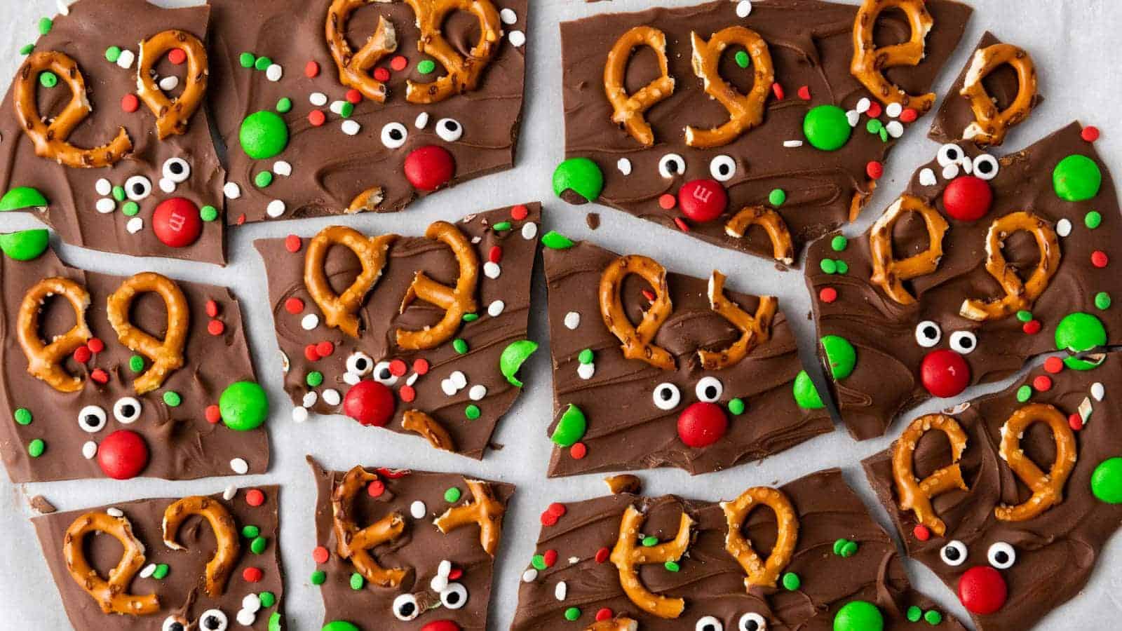 Reindeer chocolate bark pieces laid out on a light colored surface.