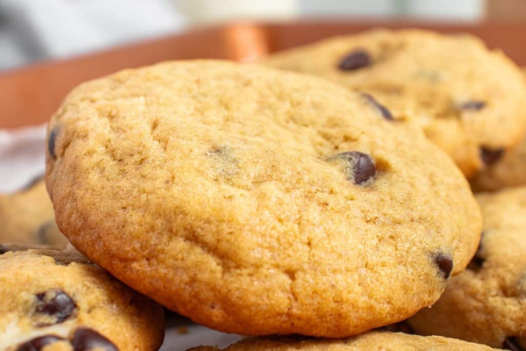 Close-up of a stack of chocolate chip cookies on a plate.