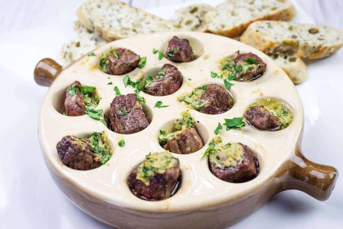 Escargot-style Garlic Butter Steak Bites in a round dish.