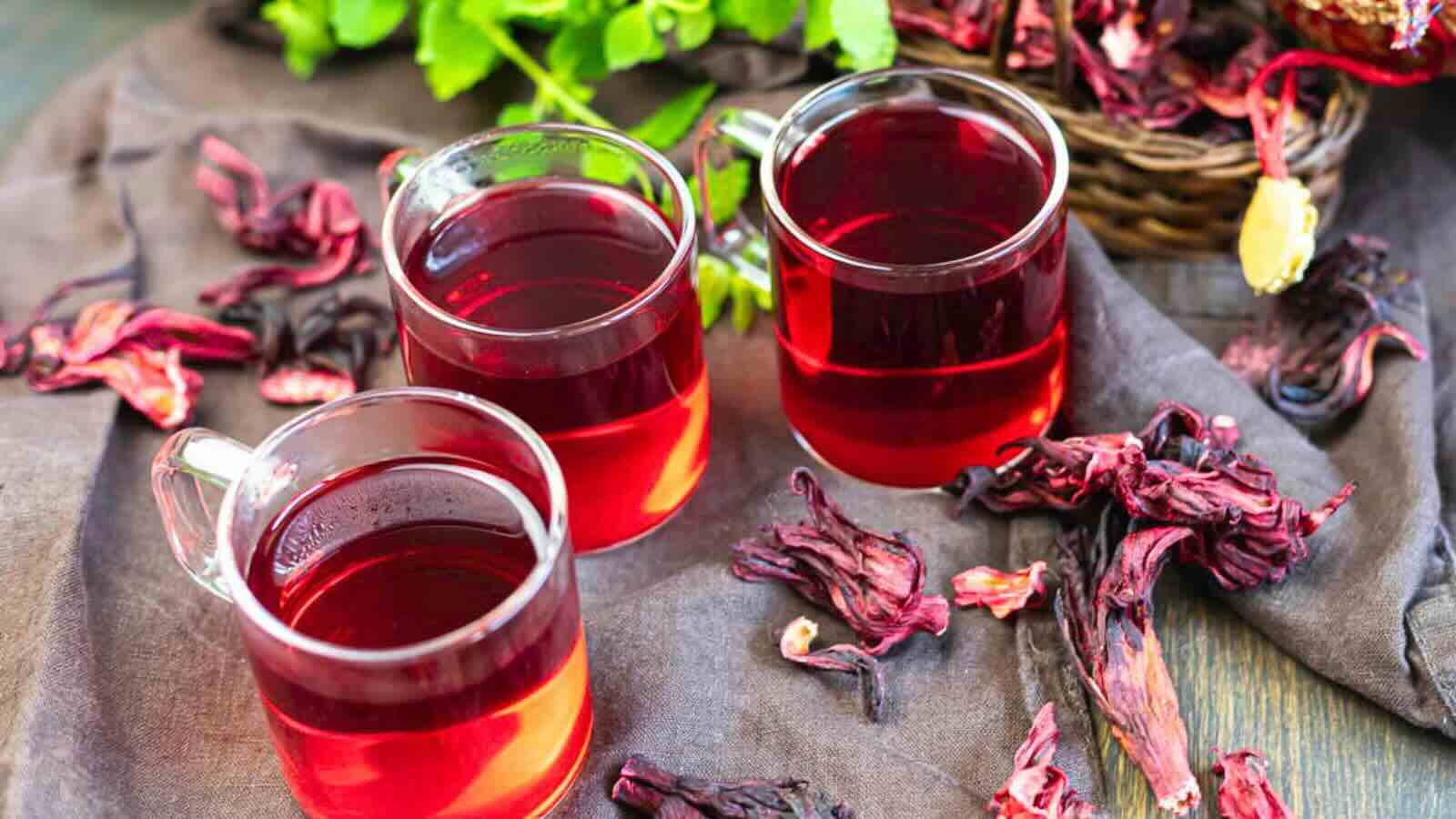 Mugs filled with red hibiscus tea.