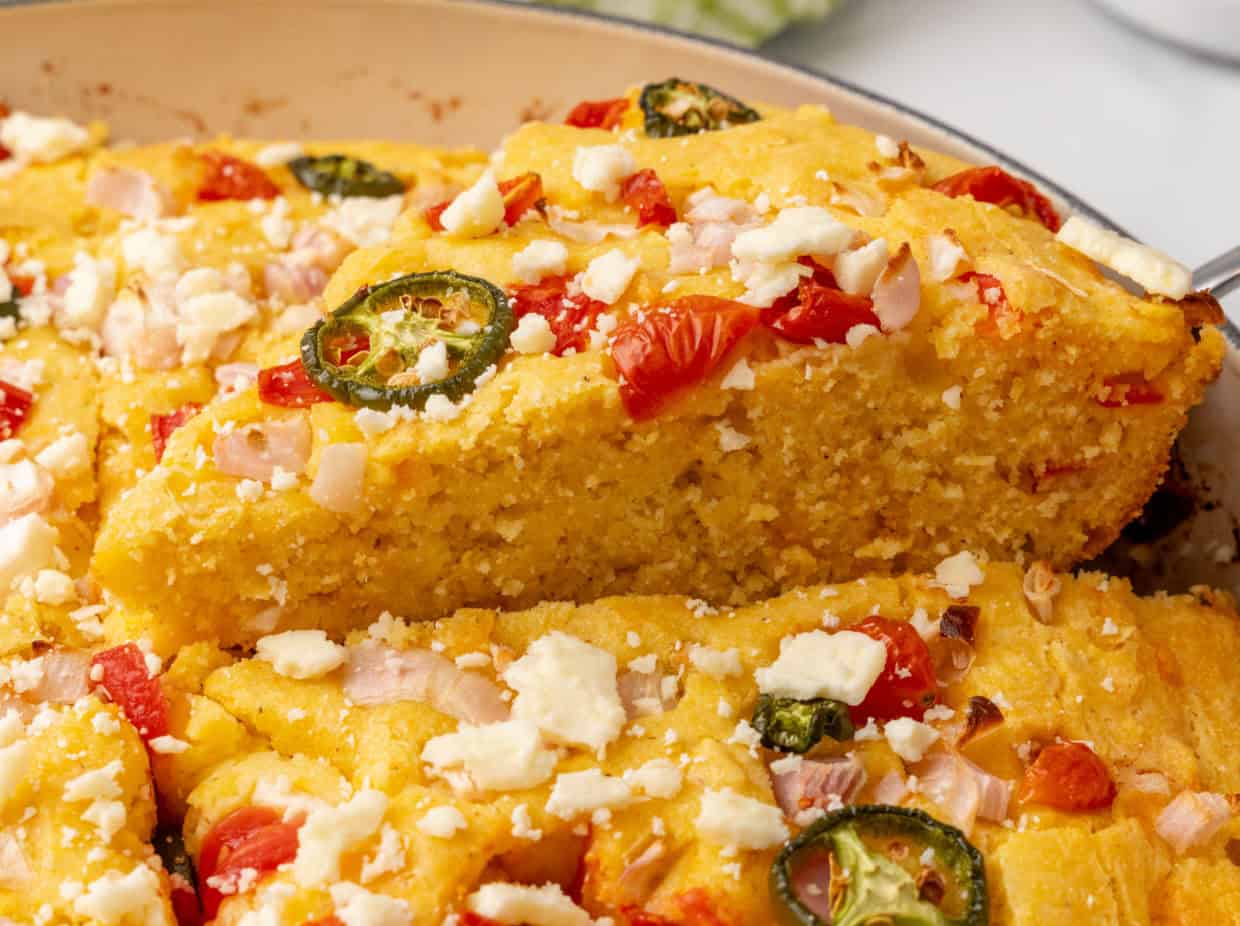 Iron skillet cornbread filled with vegetables and cheese.
