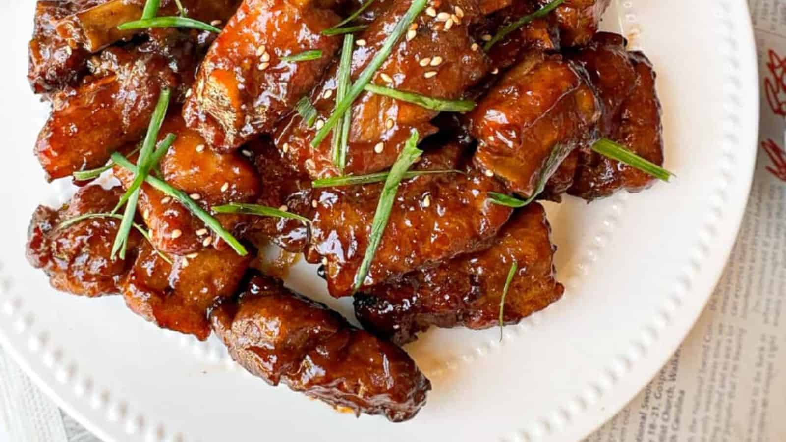 Sticky and flavorful Peking-style spare ribs on a plate.