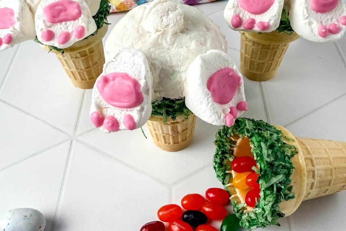 Image of 3 bunny butt cupcakes with jelly beans on counter.