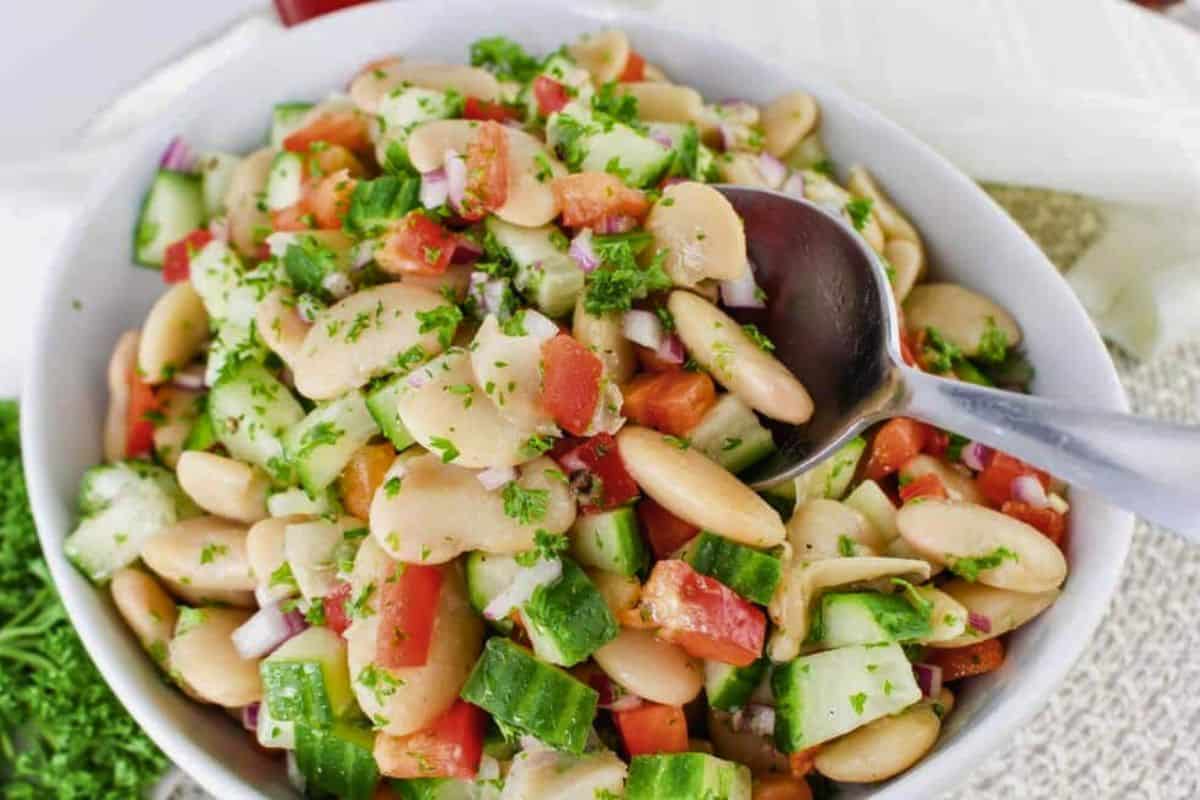 Bowl full of butter bean salad on a table.