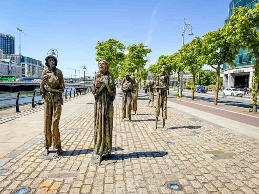 Bronze statues of emaciated figures line Dublin&rsquo;s powerful Famine Memorial Trail along the riverside walkway, commemorating the Great Irish Famine.