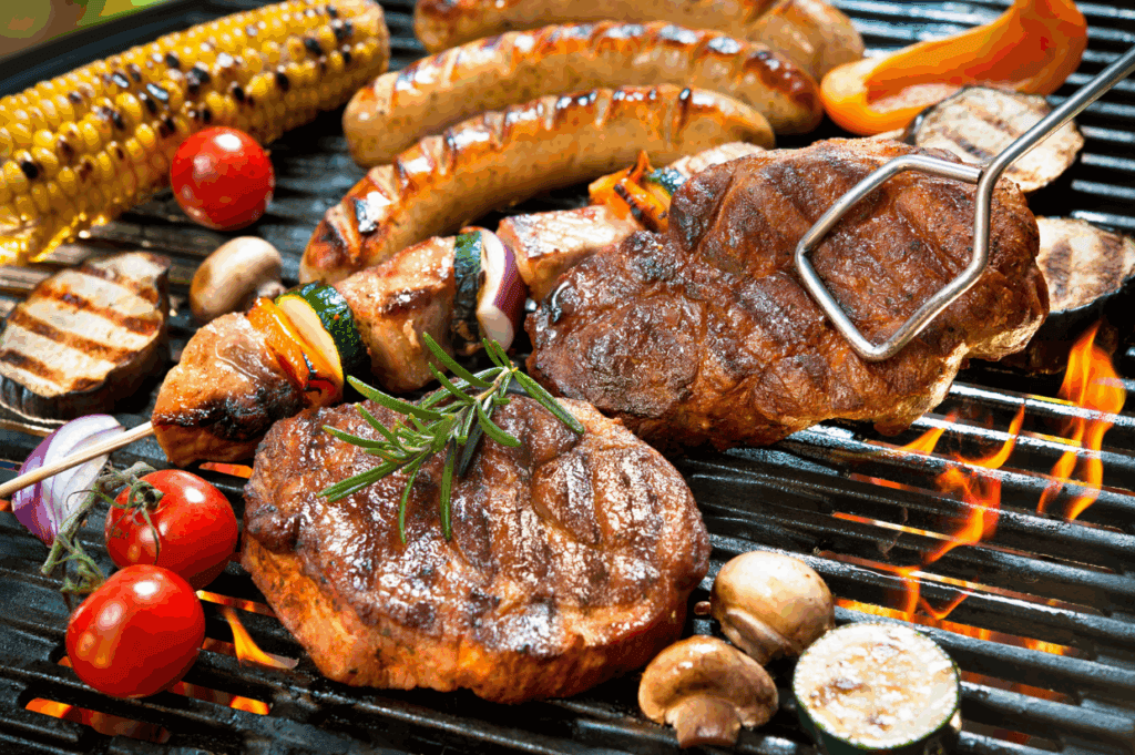 Various meats, sausages, grilled vegetables, and corn on the cob sizzle on a barbecue grill over an open flame, with a grilling fork turning a steak&mdash;showcasing bbq order by region.