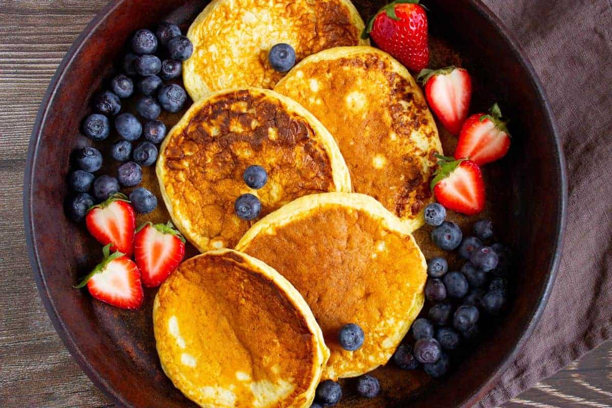 High-protein cottage cheese pancakes stacked with fresh berries.