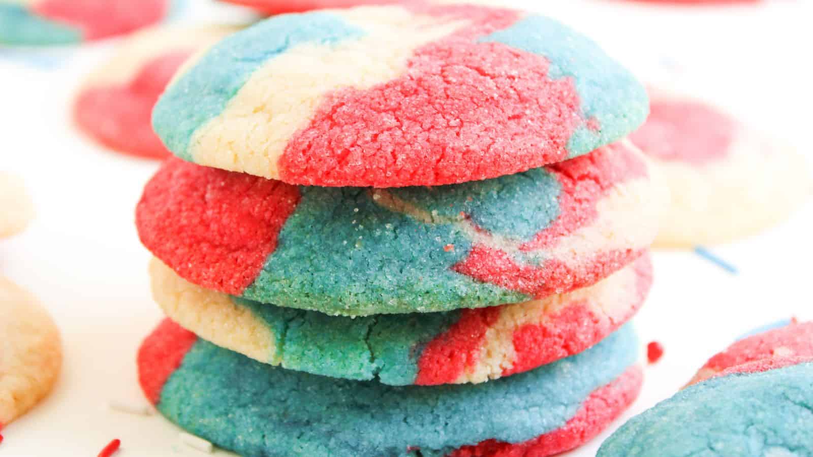 A stack of round cookies with a marbled pattern of red, blue, and white colors.