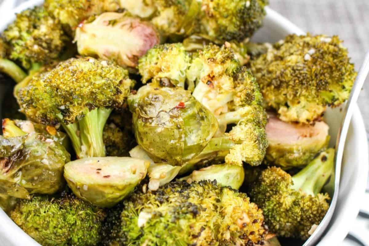 A bowl filled with roasted Brussels sprouts and broccoli.