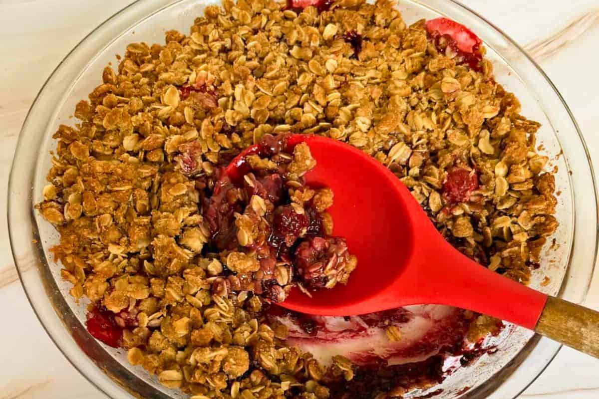 Strawberry crisp with oatmeal topping and blackberries.