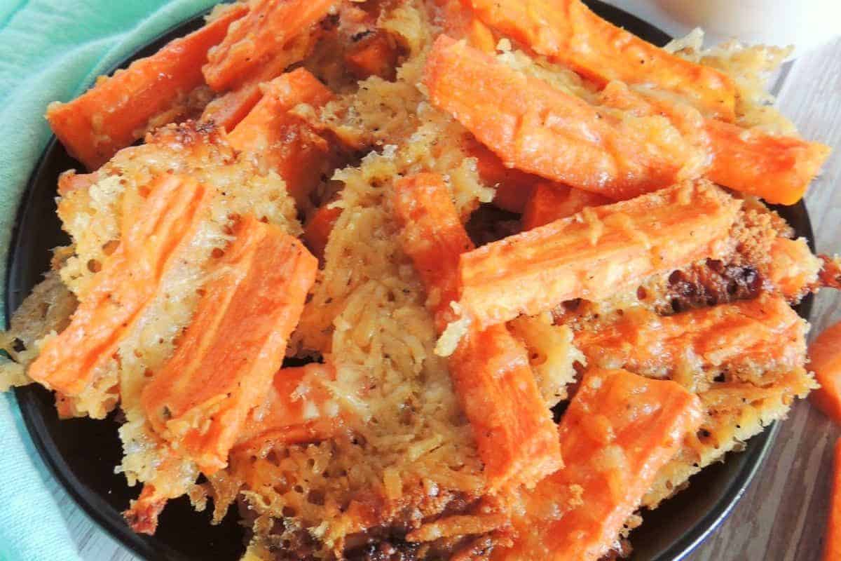 A plate of crispy carrot parmesan fries, with a golden-brown appearance.