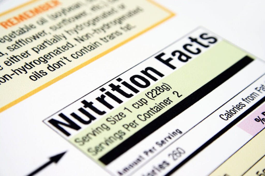 Close-up of a nutrition facts label showing serving size, servings per container, and calories per serving.