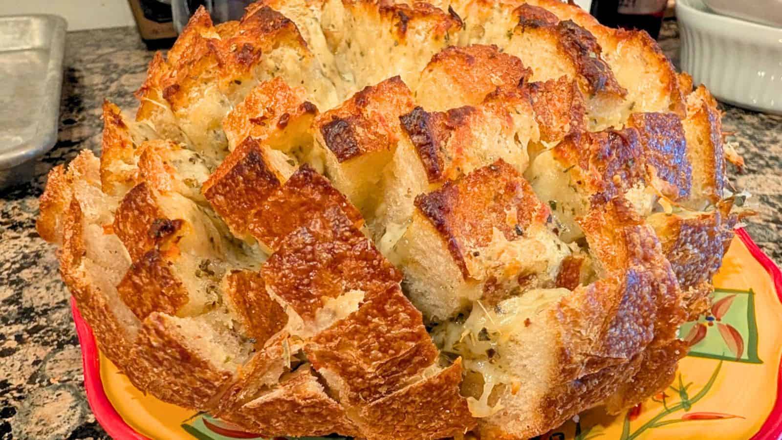 A person is grabbing a piece of bread.