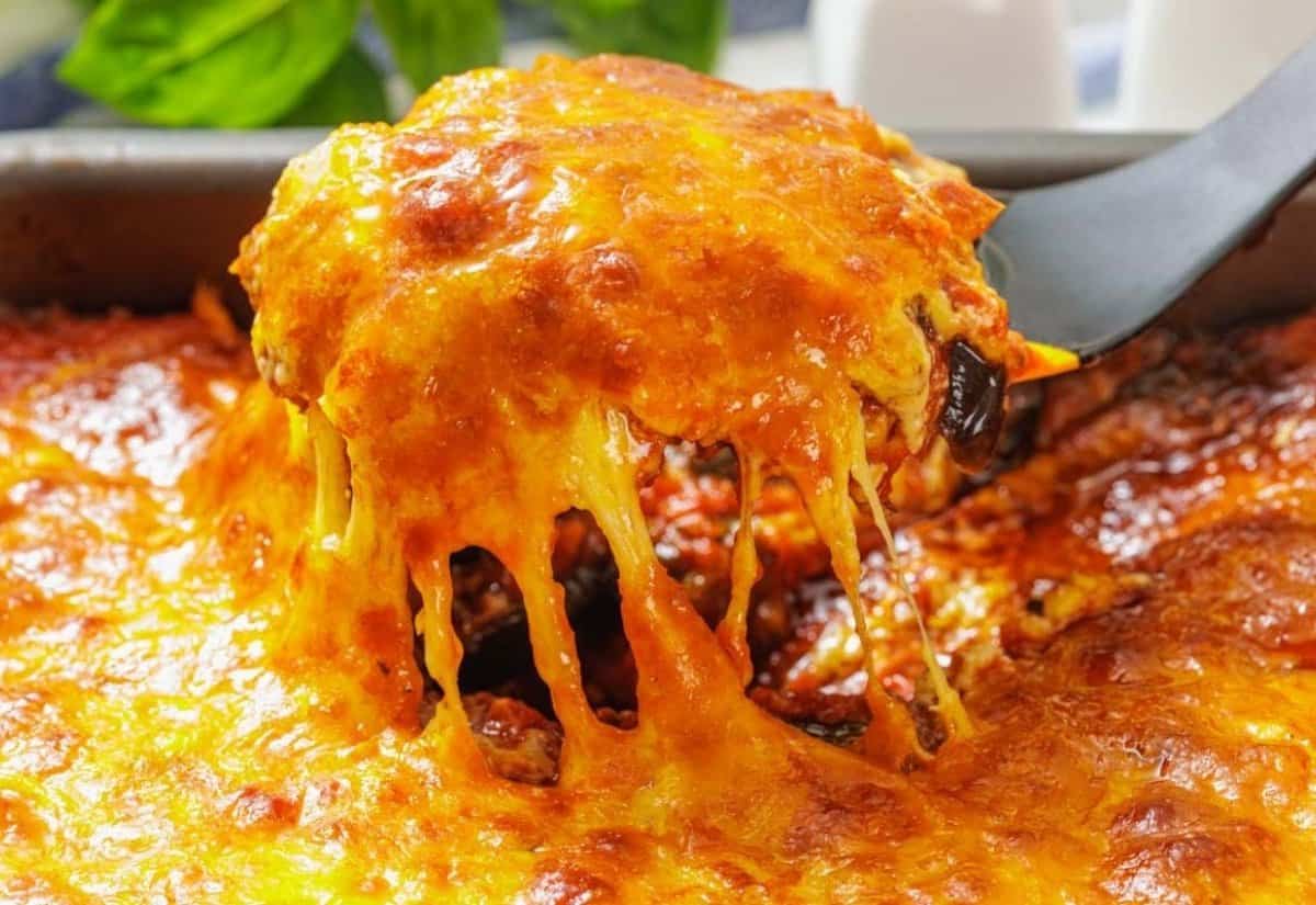 Cheesy eggplant parmigiana in a baking dish.