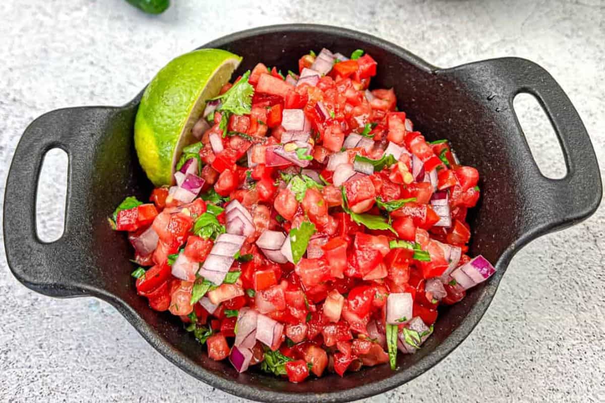 Pico de Gallo on a black cast iron bowl.