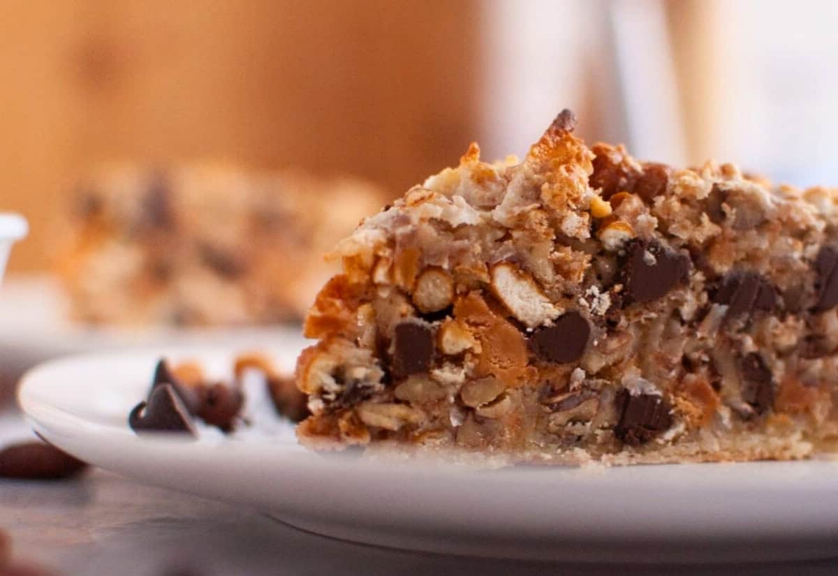 A slice of chocolate chip cookie cake on a plate.