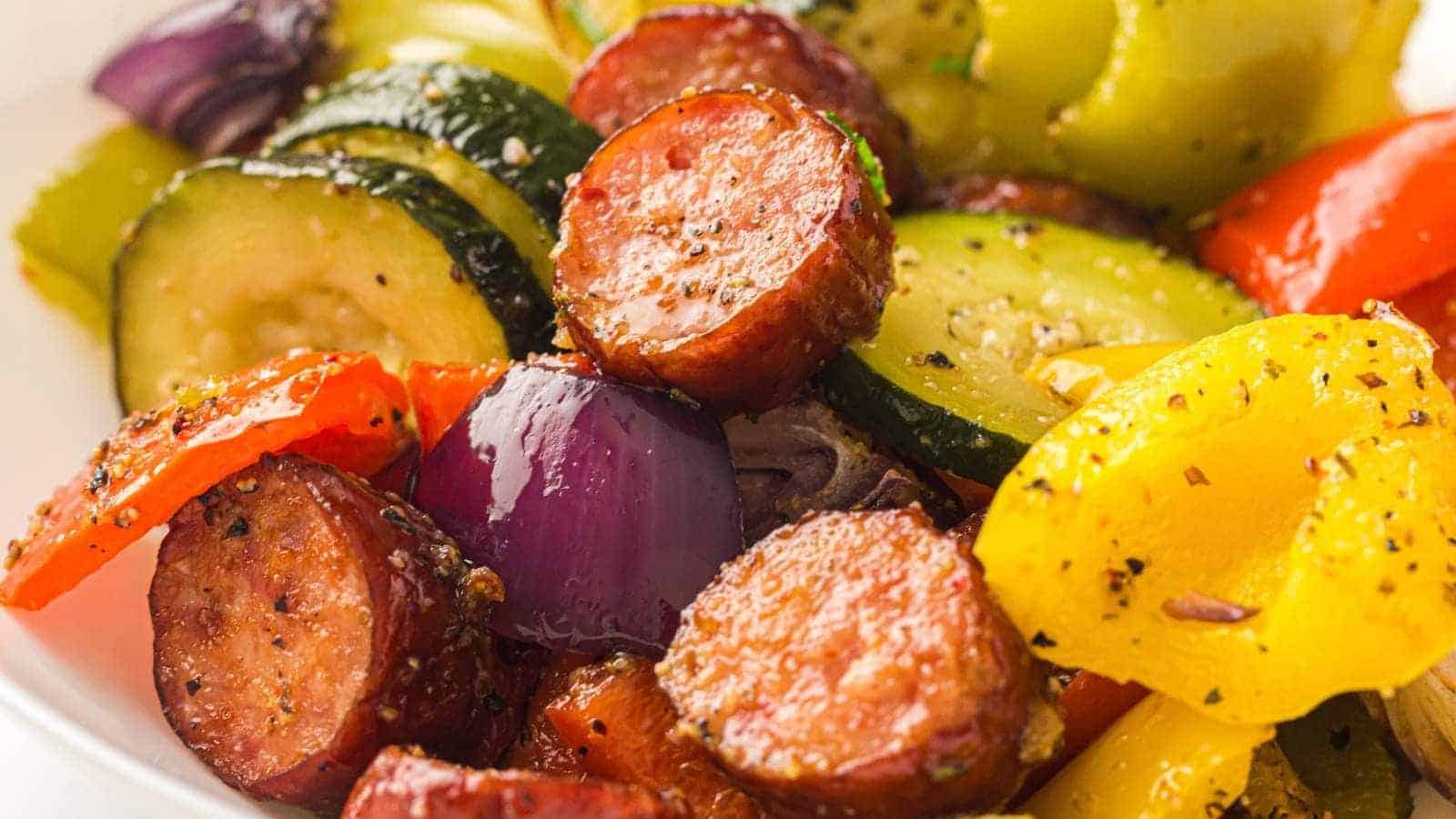 A flavorful meal of sausage and vegetables is ready to serve.