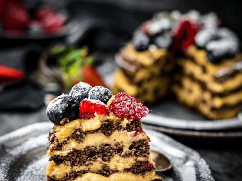 Chocolate Chaffle Cake on a plate with whole cake in the background.