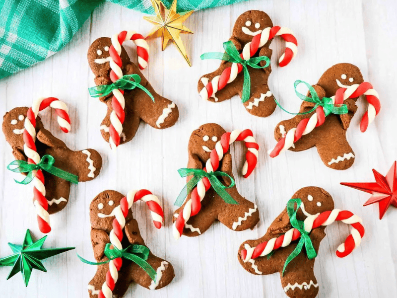 Gingerbread cookies with candy canes on a table.