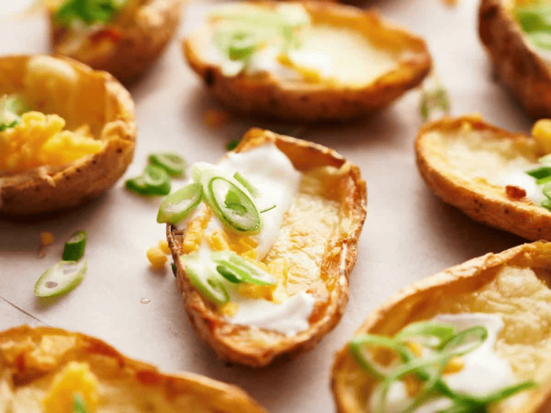 Potato skins with sour cream and sliced scallions.