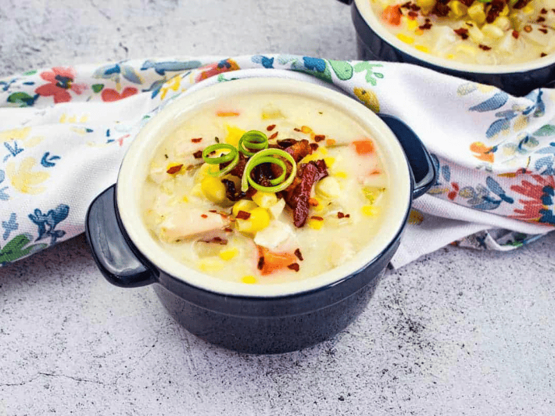 A bowl of Turkey & Corn Chowder garnished with the reserved crispy bacon.