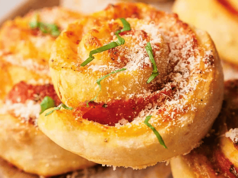 Freshly made pizza rolls stacked on each other.