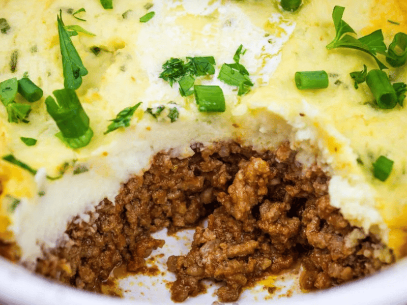 Close-up of Meatloaf Casserole with fresh herbs.