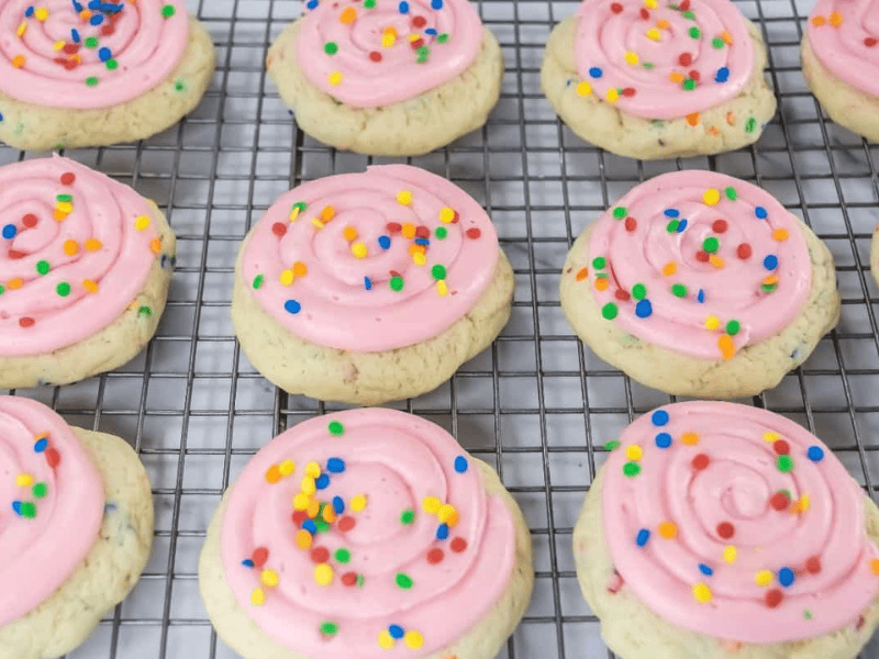 Crumbl Confetti Cake Cookies are arranged on a cooling rack.