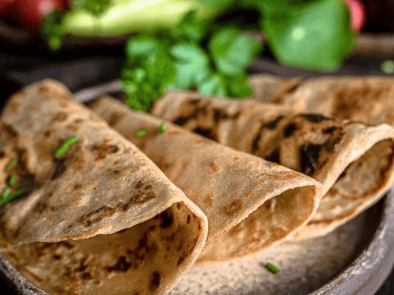 Fiber tortillas layered on a brown plate ready to consume.