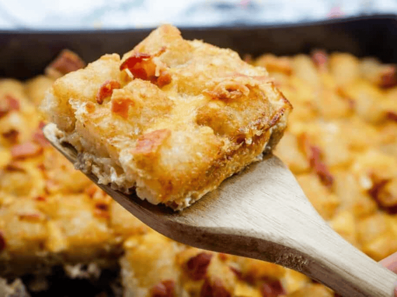 A wooden spoon with food on it.