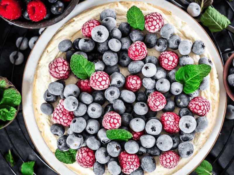 Instant Pot Keto Cheesecake with frozen berries on top.
