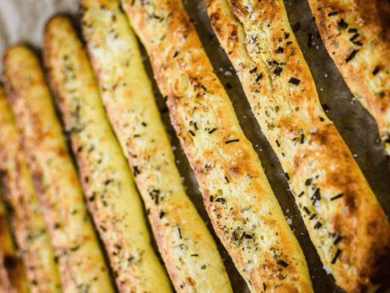Italian breadsticks on a baking tray.