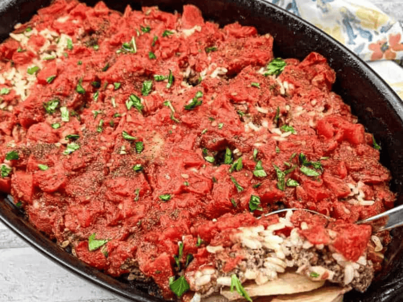 Shipwreck Casserole in a black dish with a spoon.