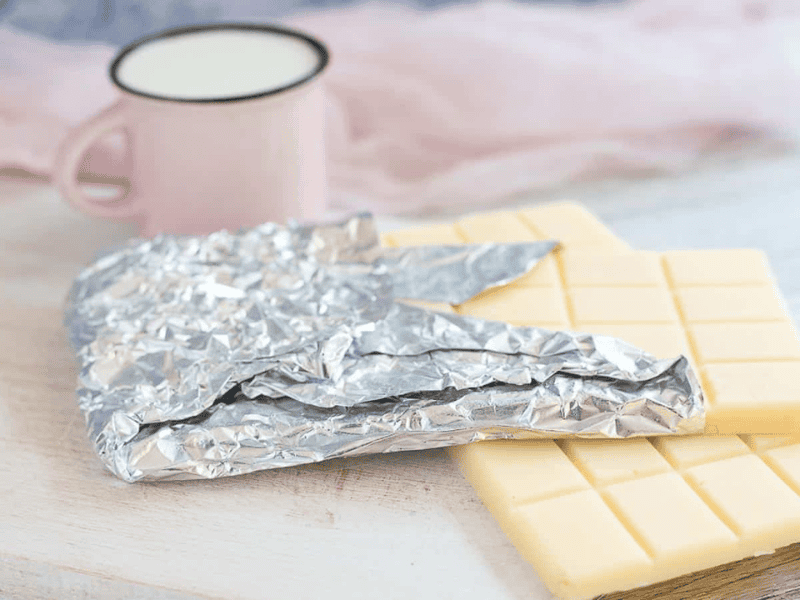 Sugar-Free White Chocolate Bar with pink jusg and napkin at the back.