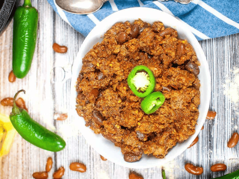 A bowl of Texas roadhouse chili with jalapenos and beans.