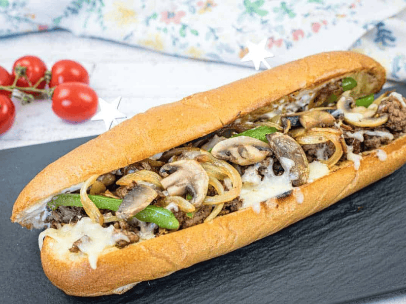 Ground Beef Philly Cheesesteak on a black slate plate.