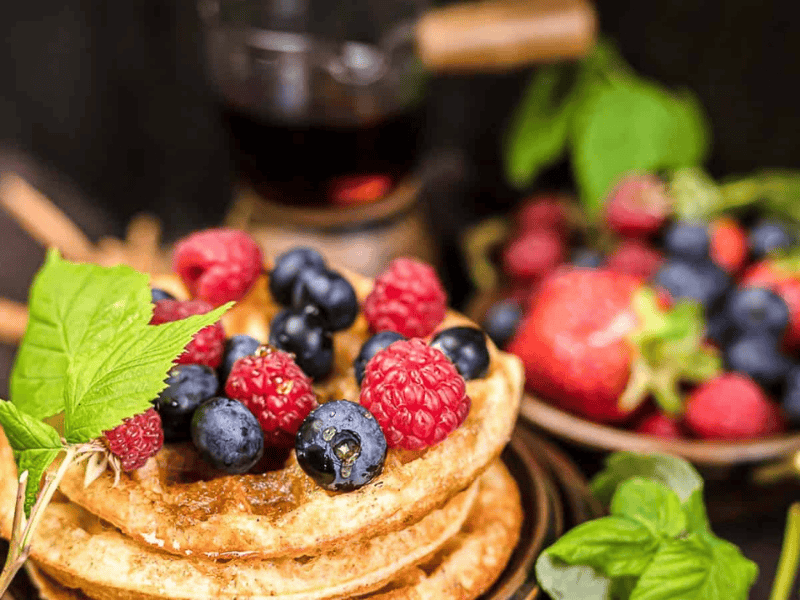Sweet Cinnamon Cream Cheese Chaffle on a plate with berries.