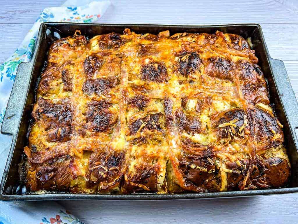 A Hot Cross Bun Breakfast Casserole in a rectangular pan divided into square portions.