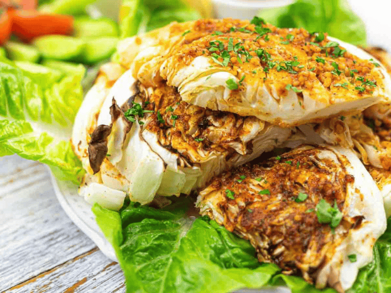 Grilled cabbage wedges seasoned with herbs and spices.