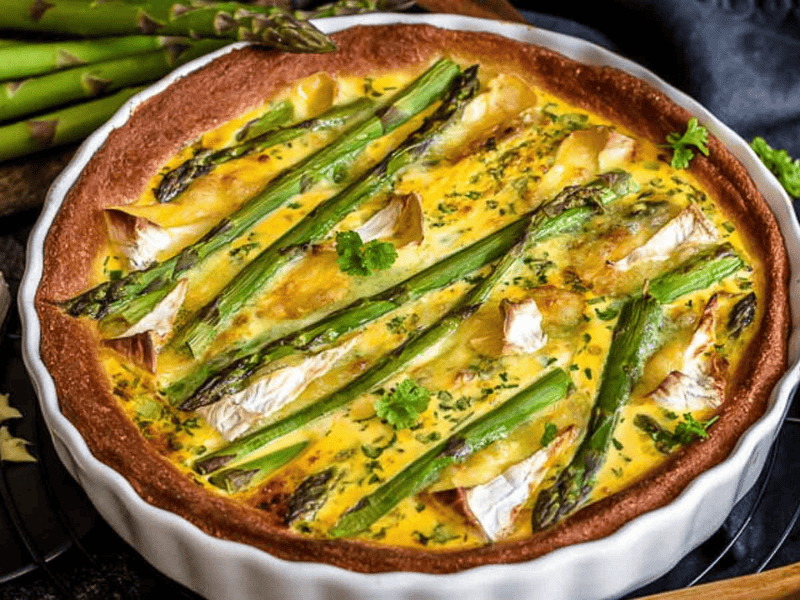 A white casserole with asparagus quiche.