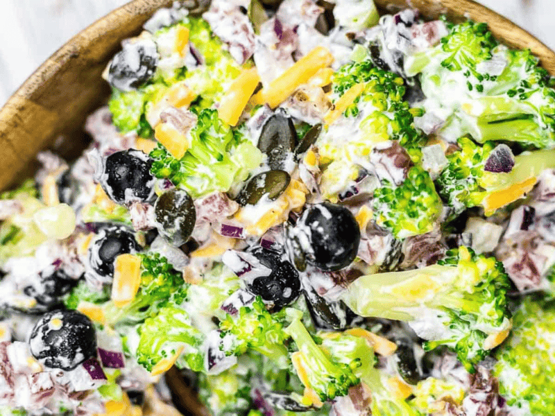 Broccoli Salad with Bacon inside wooden bowl.