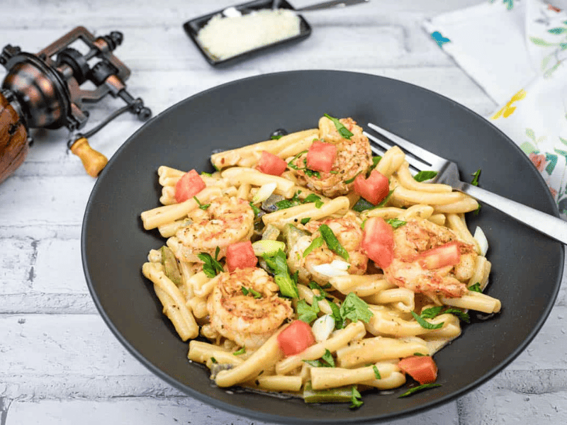 Cajun Pasta with Shrimp on a black plate.
