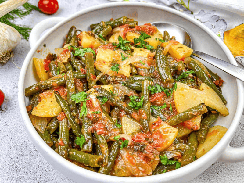 Greek Green Beans served in a white bowl.