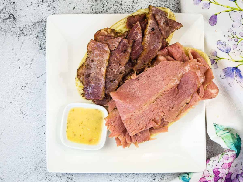 An open-face NY Steamer sub copycat on a plate with Italian dressing.