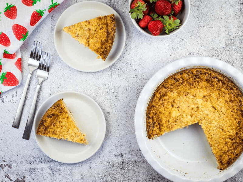 Slices of Ham & Cheese Impossible Quiche next to a whole pie.