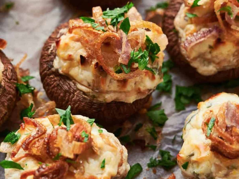 Stuffed mushrooms with crispy shallots and parsley.