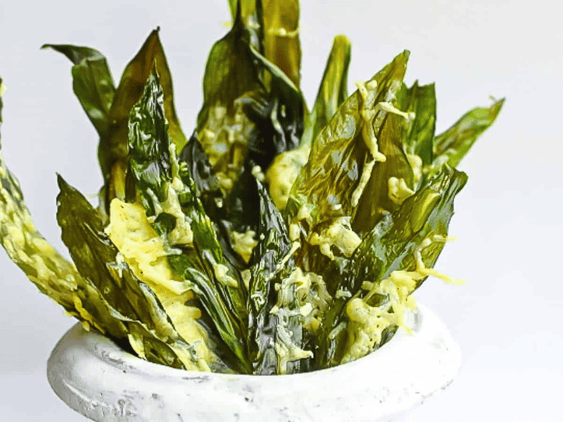 Wild Garlic Greens Chips in a pot with cheese.