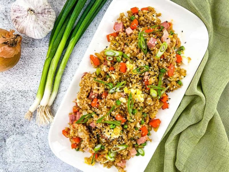 Ham fried rice on a white plate.