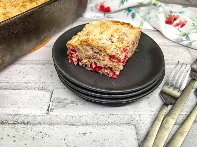 A piece of raspberry crumb cake on a plate.